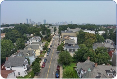 94 Walnut Avenue Boston, MA 02119 - Photo 2 of 9 an aerial view of a city with lots of residential buildings