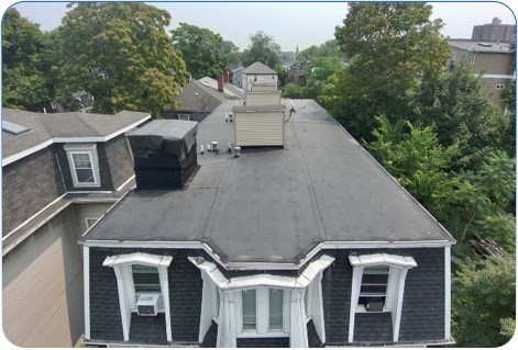 94 Walnut Avenue Boston, MA 02119 - Photo 4 of 9 a aerial view of a house with a yard