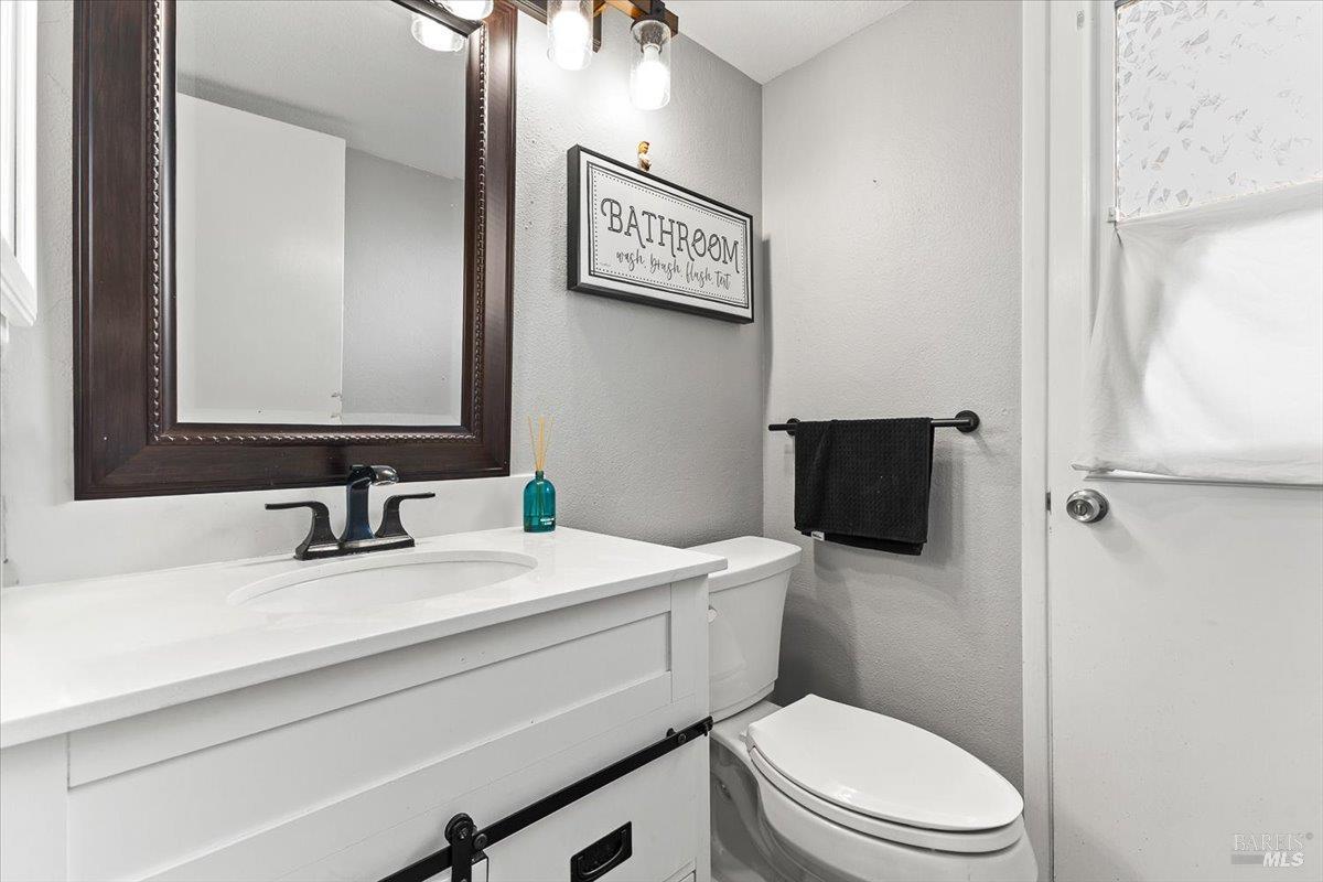 4457 Graywhaler Lane Rohnert Park, CA 94928 - Photo 34 of 51 a bathroom with a toilet a sink and mirror