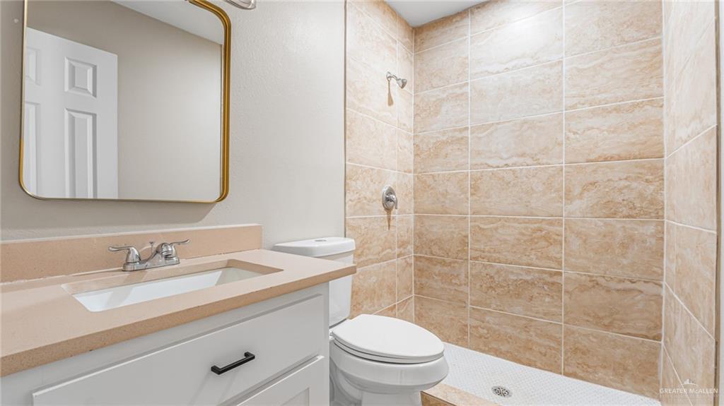 712 Toronto Avenue, Unit 1 McAllen, TX 78503 - Photo 12 of 12 a bathroom with a sink a toilet and shower
