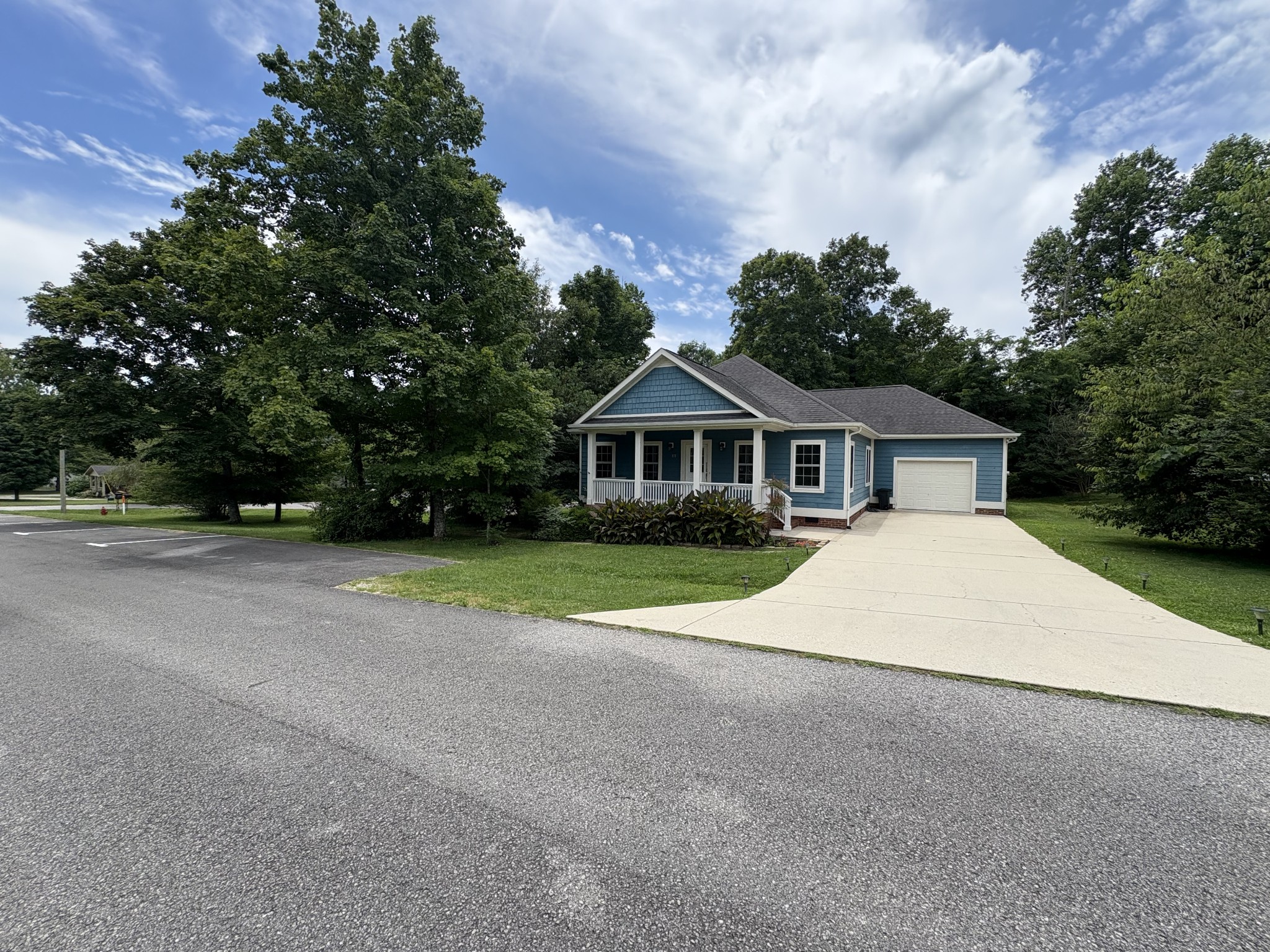 a front view of house with yard and trees