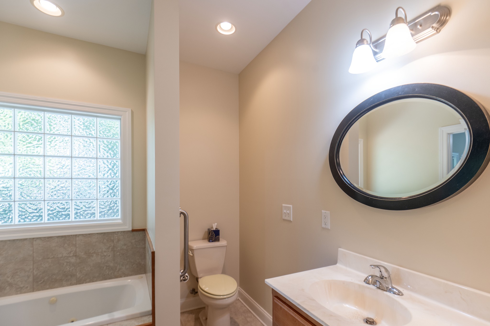 111 Reed's Lane Sewanee, TN 37375 - Photo 12 of 24 a bathroom with a toilet a sink a mirror and bathtub