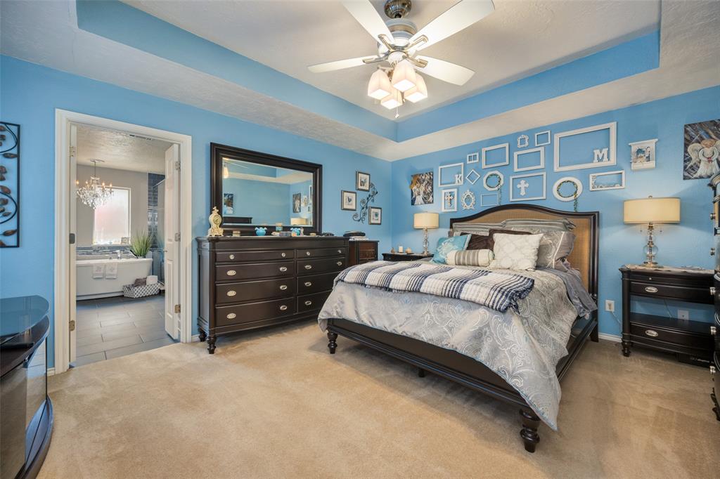 1 Finley Circle Krum, TX 76249 - Photo 13 of 30 a bedroom with a bed and a chandelier