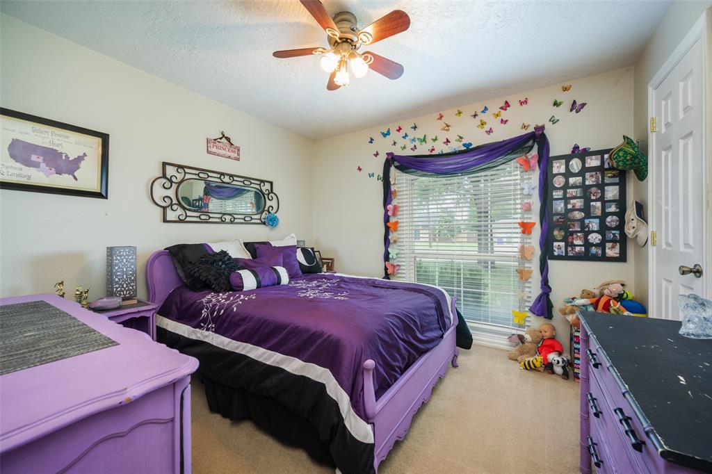 1 Finley Circle Krum, TX 76249 - Photo 17 of 30 a bed room with a bed and a baby bed