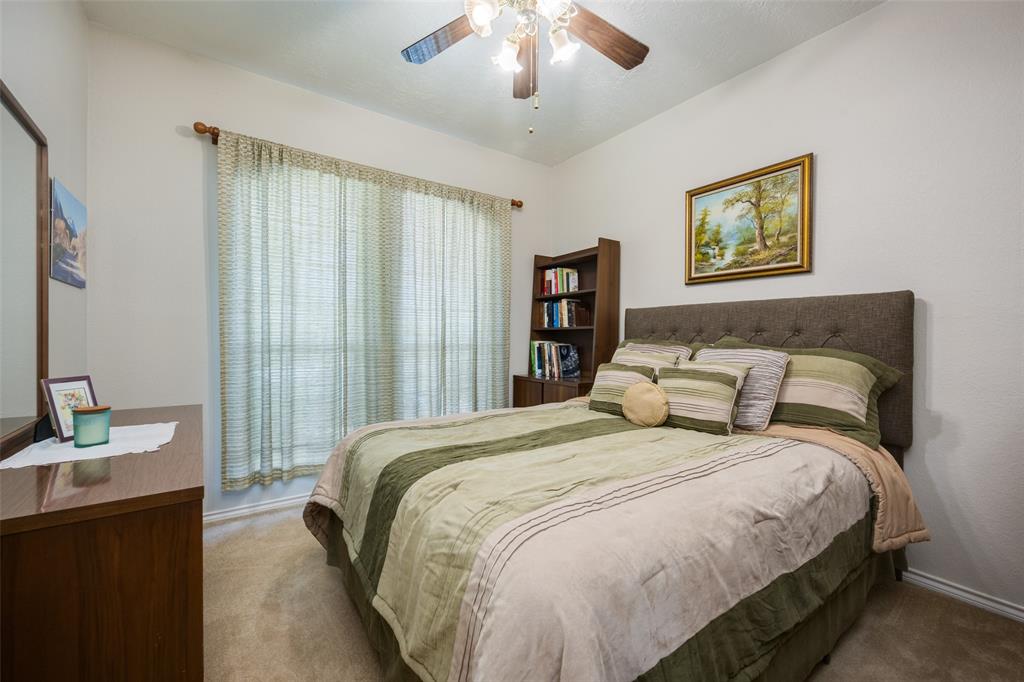 1 Finley Circle Krum, TX 76249 - Photo 18 of 30 a bedroom with a bed and a chandelier