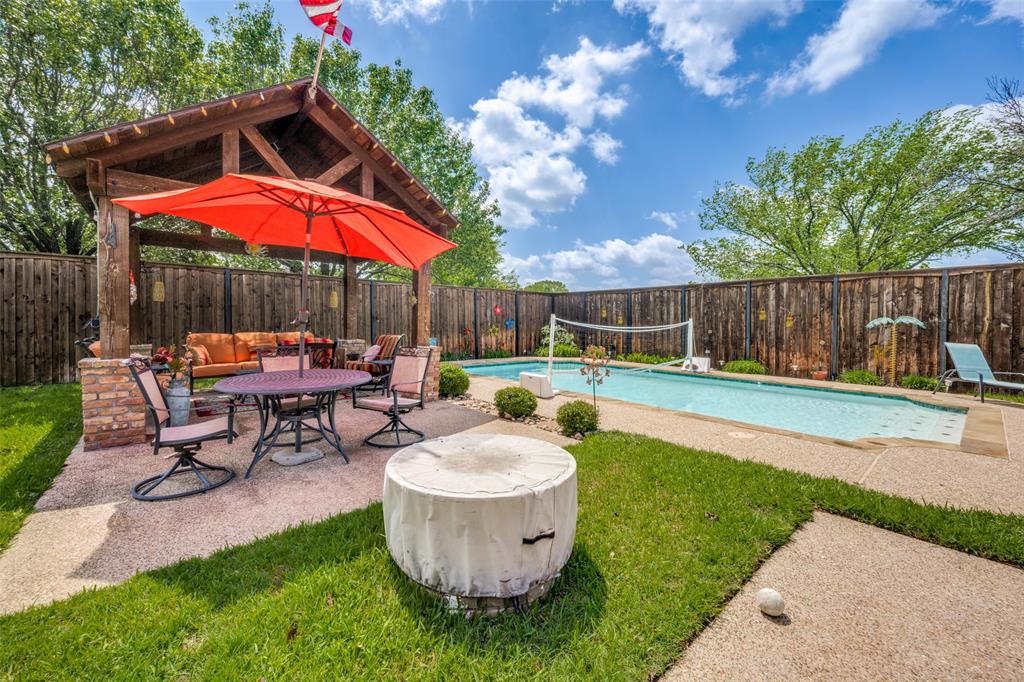 1 Finley Circle Krum, TX 76249 - Photo 25 of 30 a view of a backyard with table and chairs under an umbrella