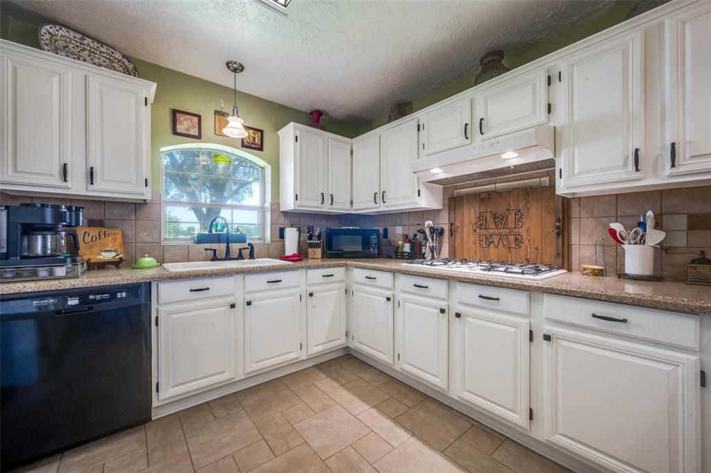1 Finley Circle Krum, TX 76249 - Photo 9 of 30 a kitchen with cabinets appliances a sink and a window