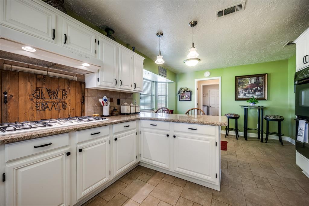 1 Finley Circle Krum, TX 76249 - Photo 10 of 30 a kitchen with cabinets and chairs