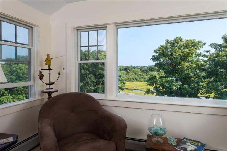 24 Champlain Road Chatham, MA 02633 - Photo 13 of 26 a living room filled with furniture and a window