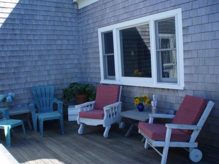 24 Champlain Road Chatham, MA 02633 - Photo 20 of 26 a wooden bench sitting in front of a building