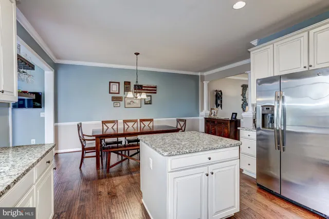 a kitchen with a center island and stainless steel appliances