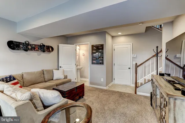 a living room with furniture and a ceiling fan