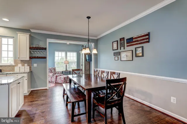 a dining room with furniture a chandelier and window