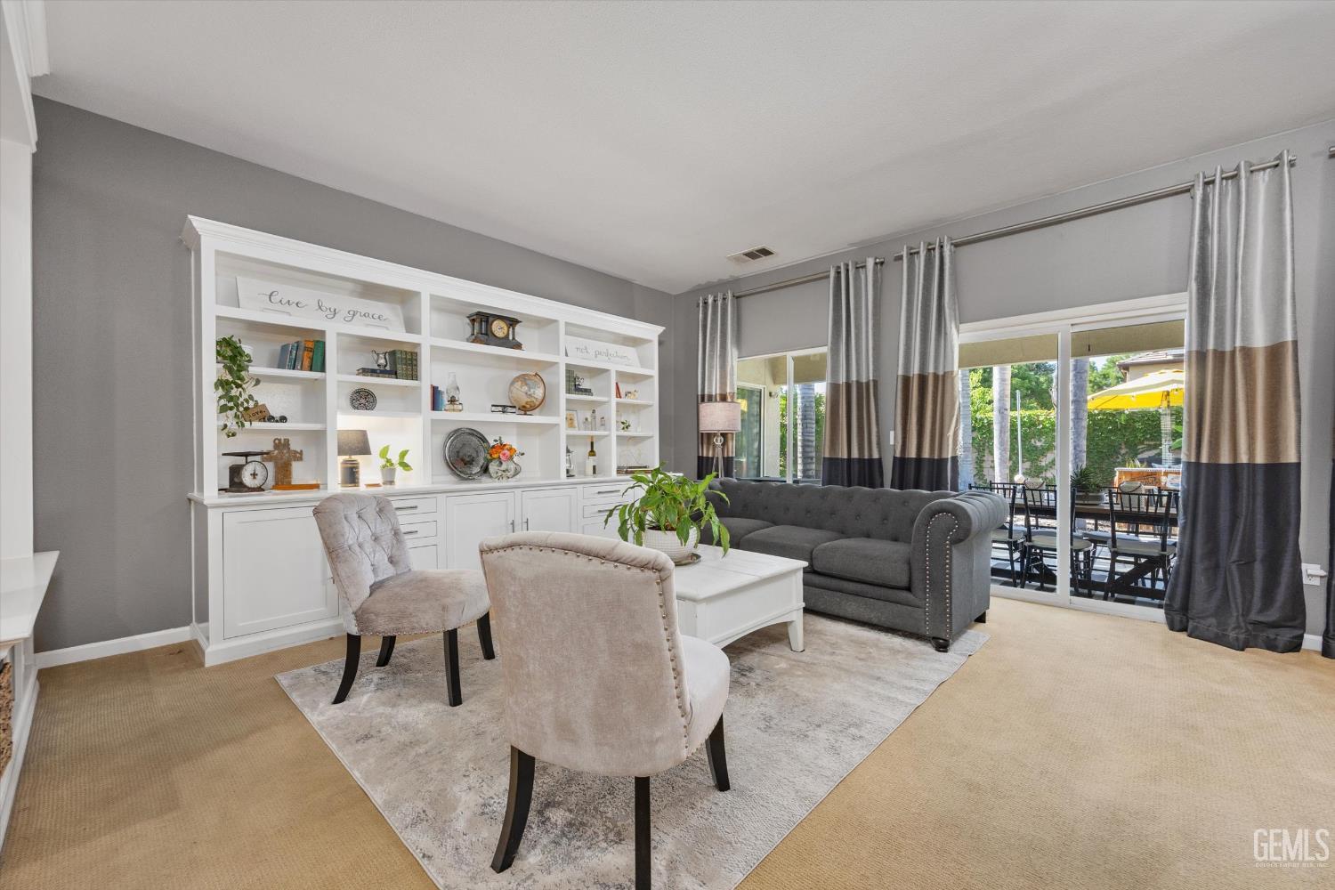 Undisclosed Address Bakersfield, CA 93312 - Photo 12 of 61 a living room with furniture and a large window