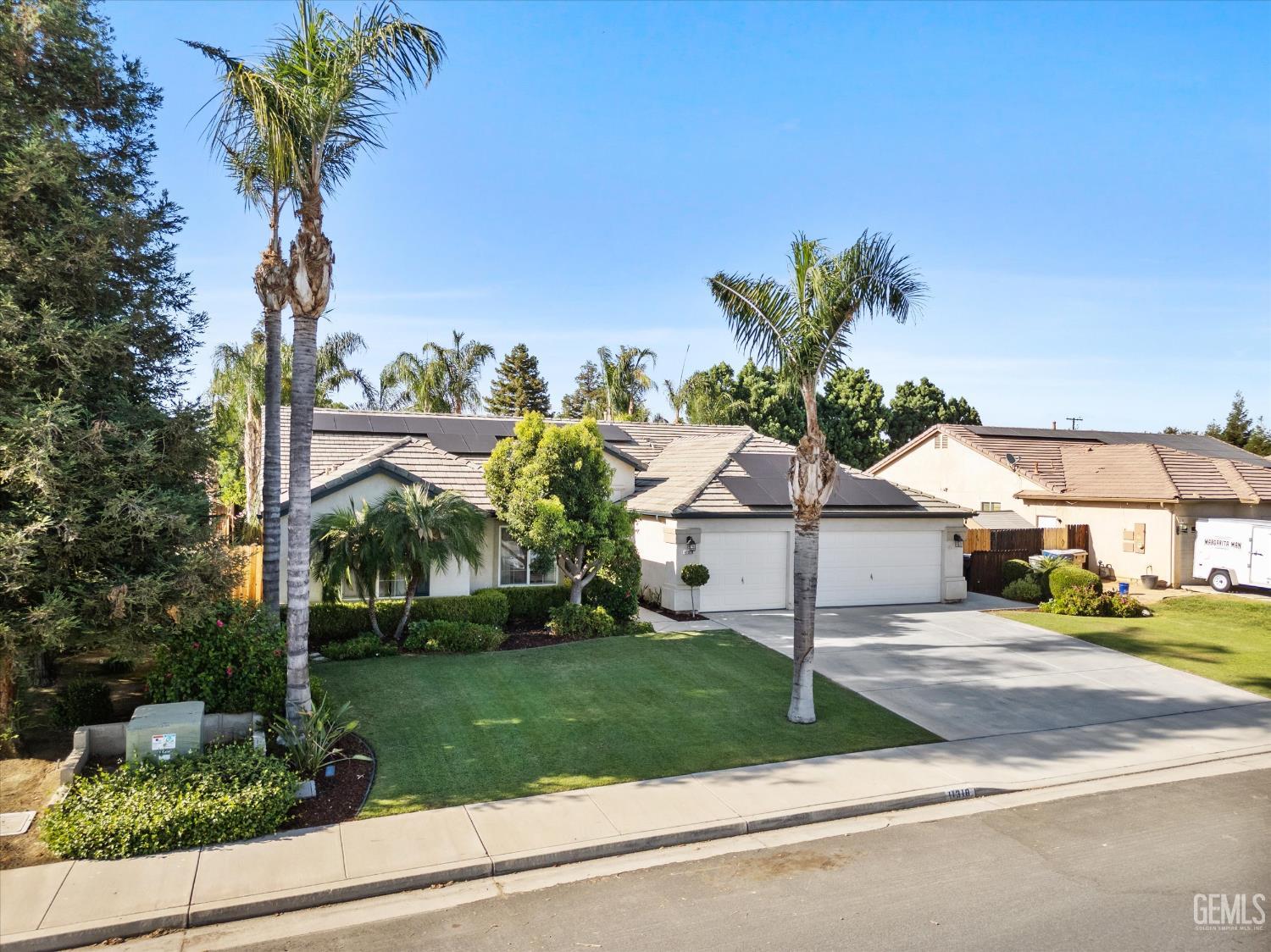 Undisclosed Address Bakersfield, CA 93312 - Photo 2 of 61 a front view of a house with a yard
