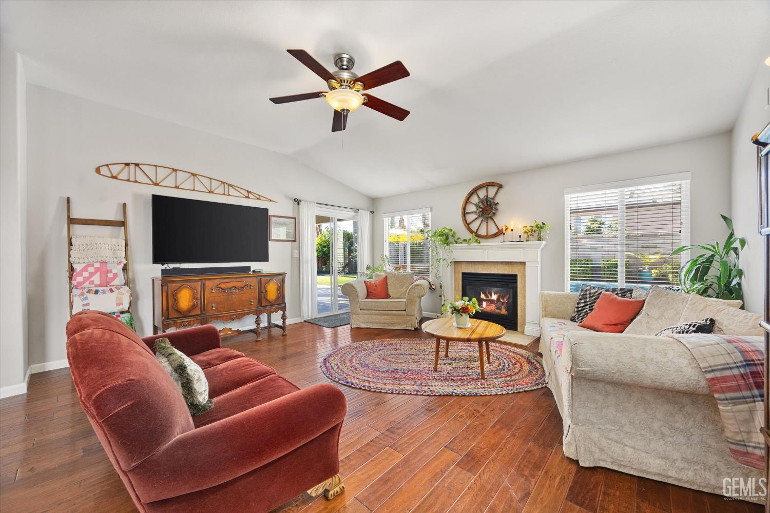 Undisclosed Address Bakersfield, CA 93312 - Photo 21 of 61 a living room with furniture a fireplace and a flat screen tv