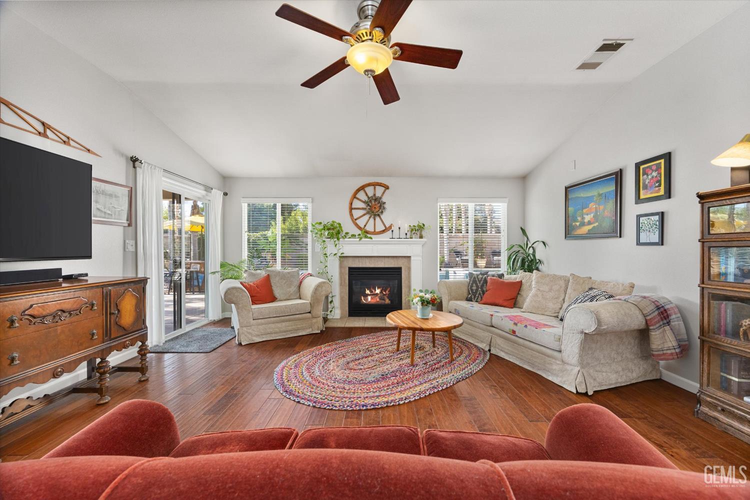 Undisclosed Address Bakersfield, CA 93312 - Photo 22 of 61 a living room with furniture a fireplace and a flat screen tv