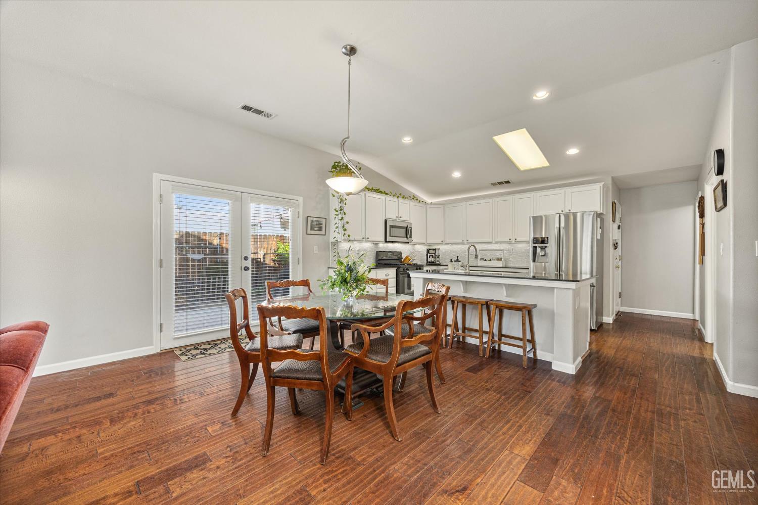 Undisclosed Address Bakersfield, CA 93312 - Photo 26 of 61 a view of a dining room and livingroom with furniture wooden floor a chandelier