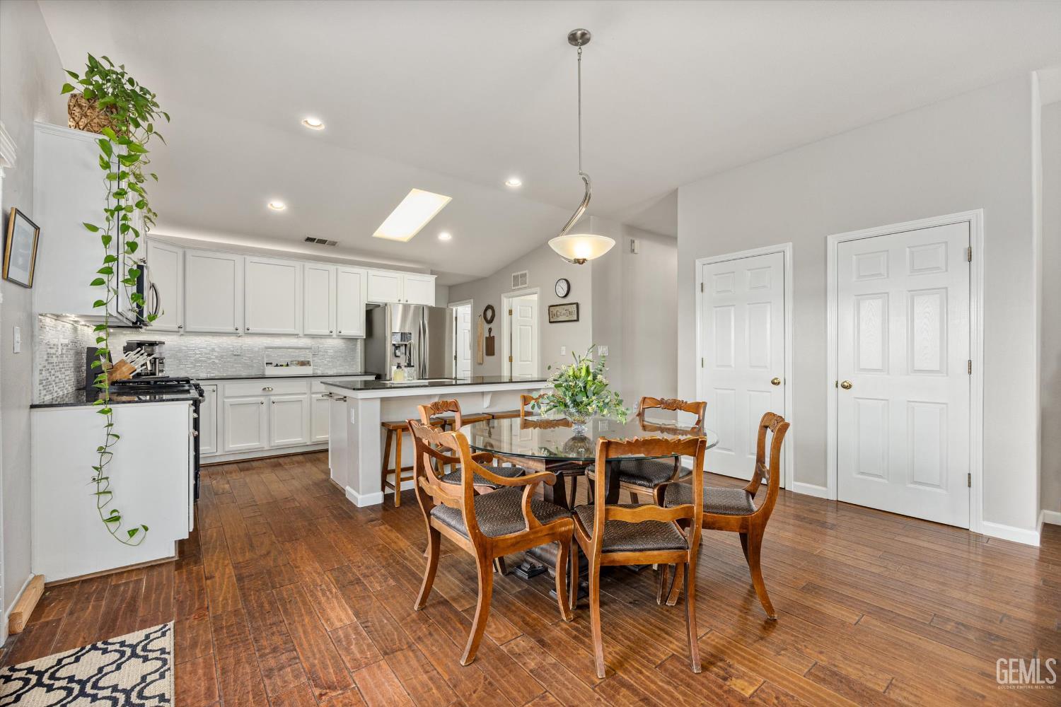 Undisclosed Address Bakersfield, CA 93312 - Photo 27 of 61 a view of a dining room with furniture and wooden floor