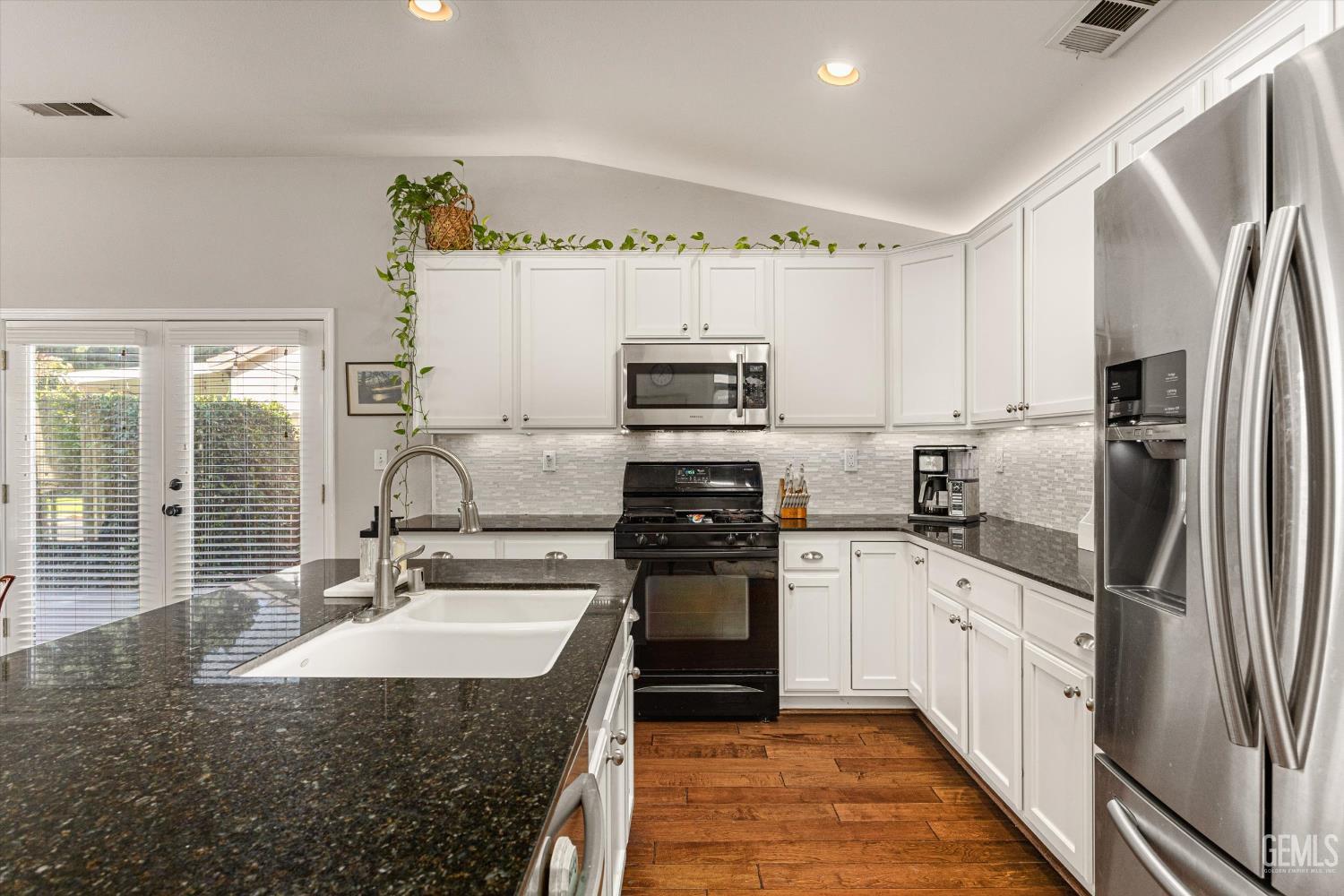 Undisclosed Address Bakersfield, CA 93312 - Photo 31 of 61 a kitchen with stainless steel appliances granite countertop a sink stove and refrigerator