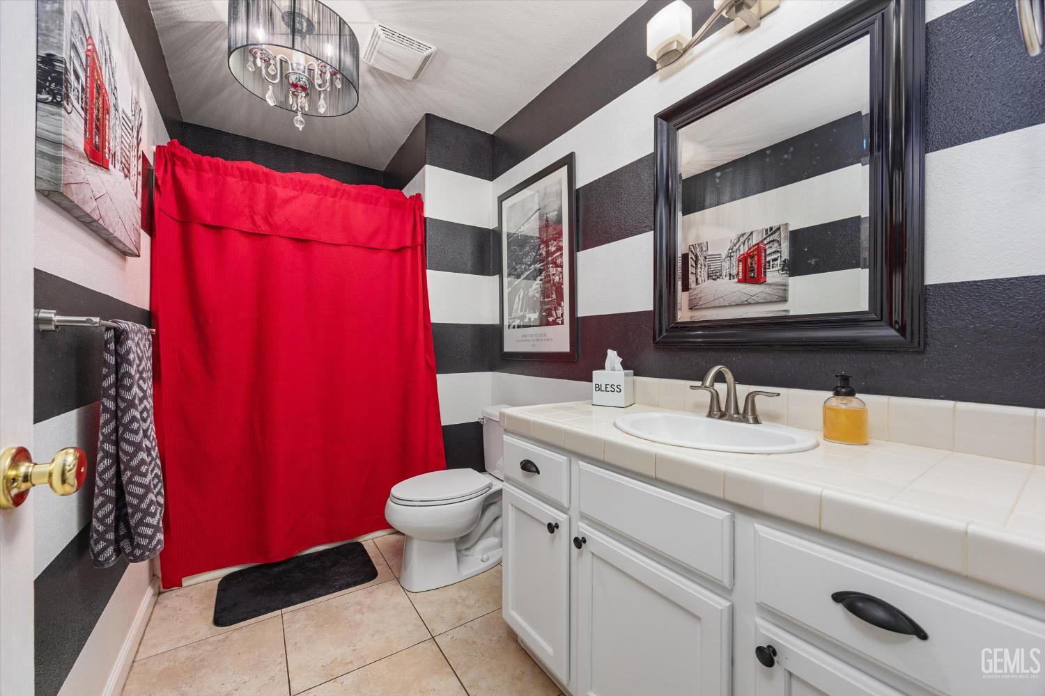 Undisclosed Address Bakersfield, CA 93312 - Photo 45 of 61 a bathroom with a toilet sink and mirror