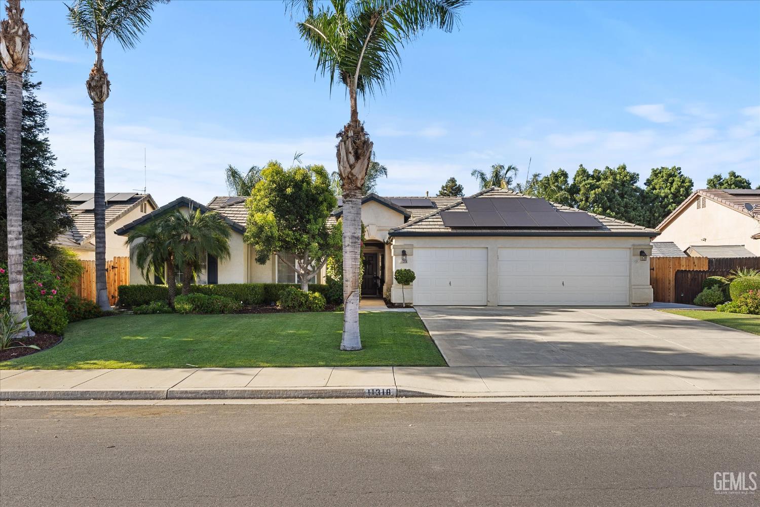 Undisclosed Address Bakersfield, CA 93312 - Photo 9 of 61 a front view of a house with a garden and yard