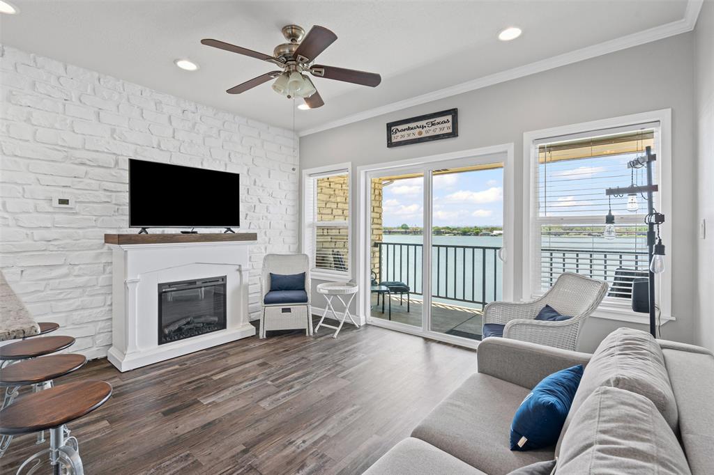 Living room featuring recessed lighting, wood finished floors, and ceiling fan, and a spectacular view of lake granbury