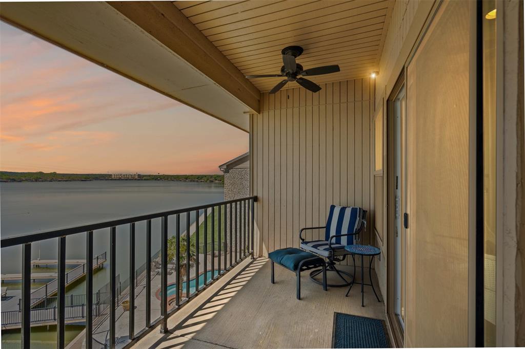 401 East Pearl Street, Unit 2306 Granbury, TX 76048 - Photo 3 of 17 Balcony at dusk with ceiling fan and a water view