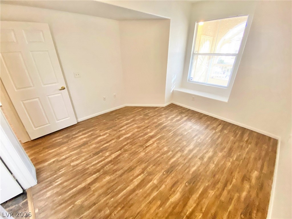 10550 West Alexander Road, Unit 1131 Las Vegas, NV 89129 - Photo 9 of 18 A well-lit room showcases durable laminate flooring and a bright window with a deep sill.
