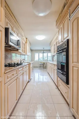 a large kitchen with stainless steel appliances and cabinets