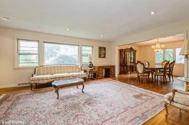 a living room with furniture a table and large windows