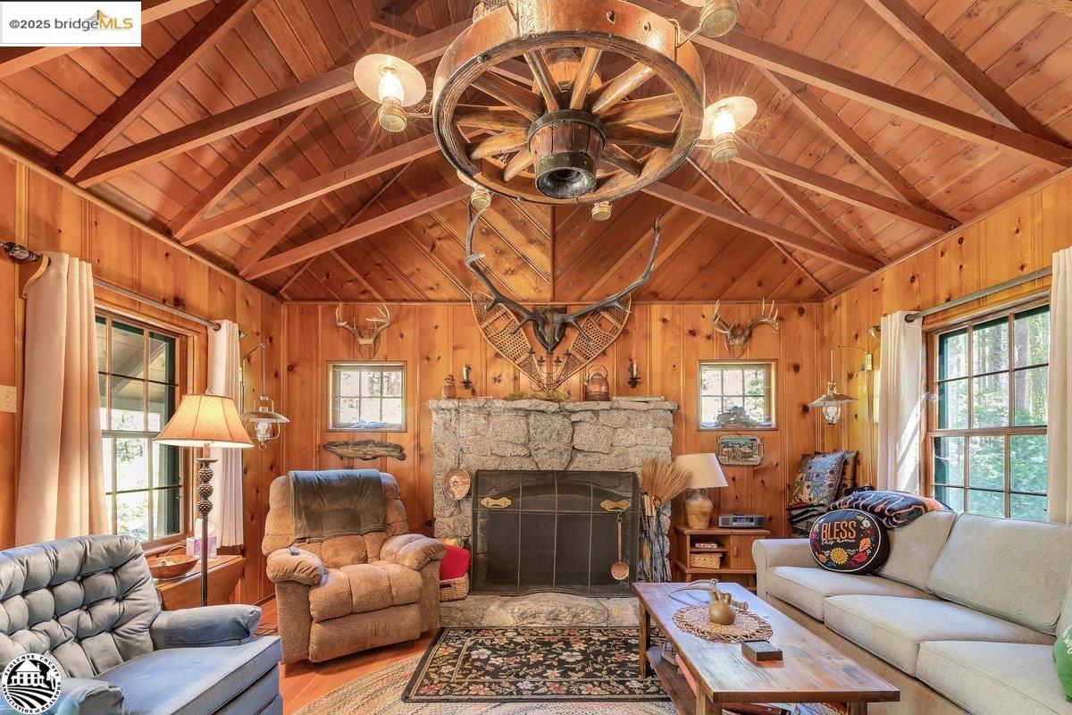 269 Meadow View Road Pinecrest, CA 95364 - Photo 1 of 1 a living room with furniture a fireplace and a table