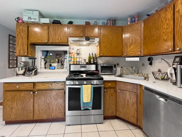 a kitchen with a sink cabinets and appliances
