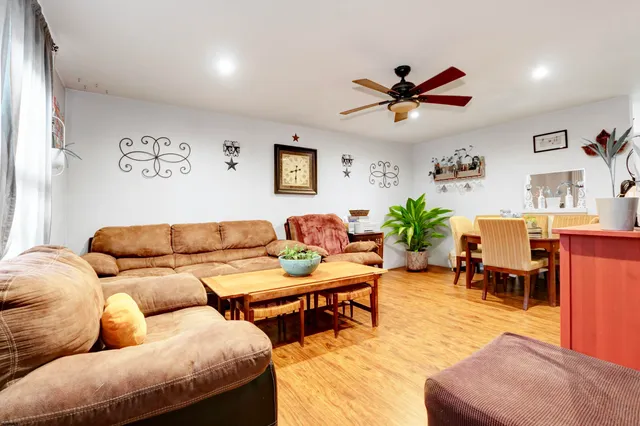 a living room with furniture and a chandelier