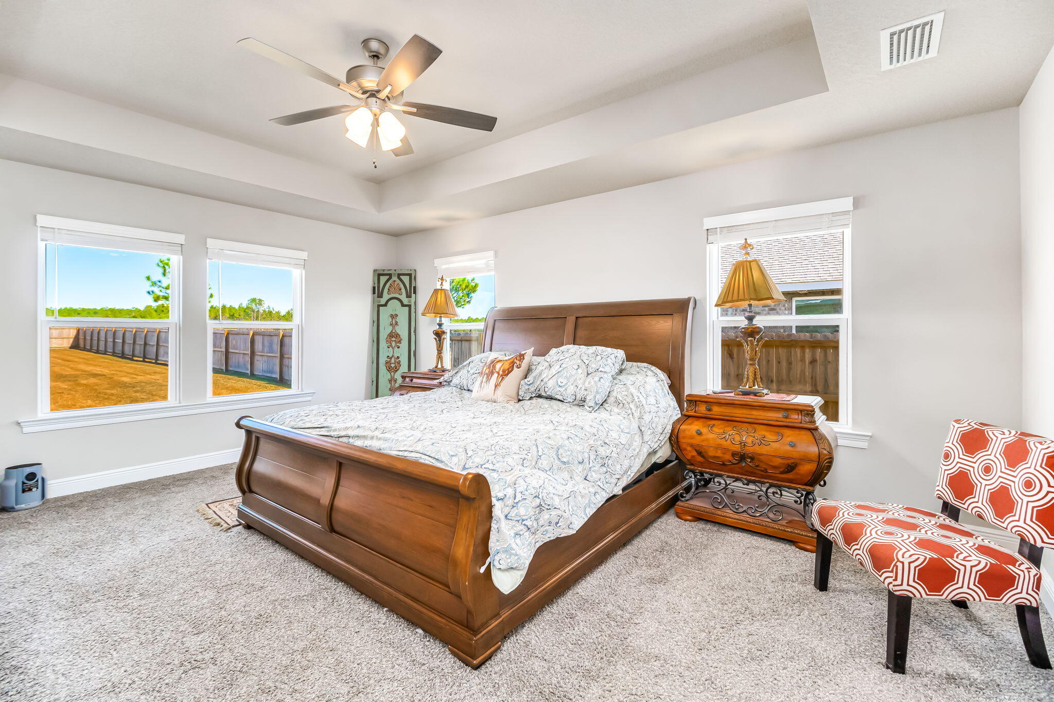 9188 Trident Road Milton, FL 32583 - Photo 17 of 47 a bedroom with a bed and a chandelier