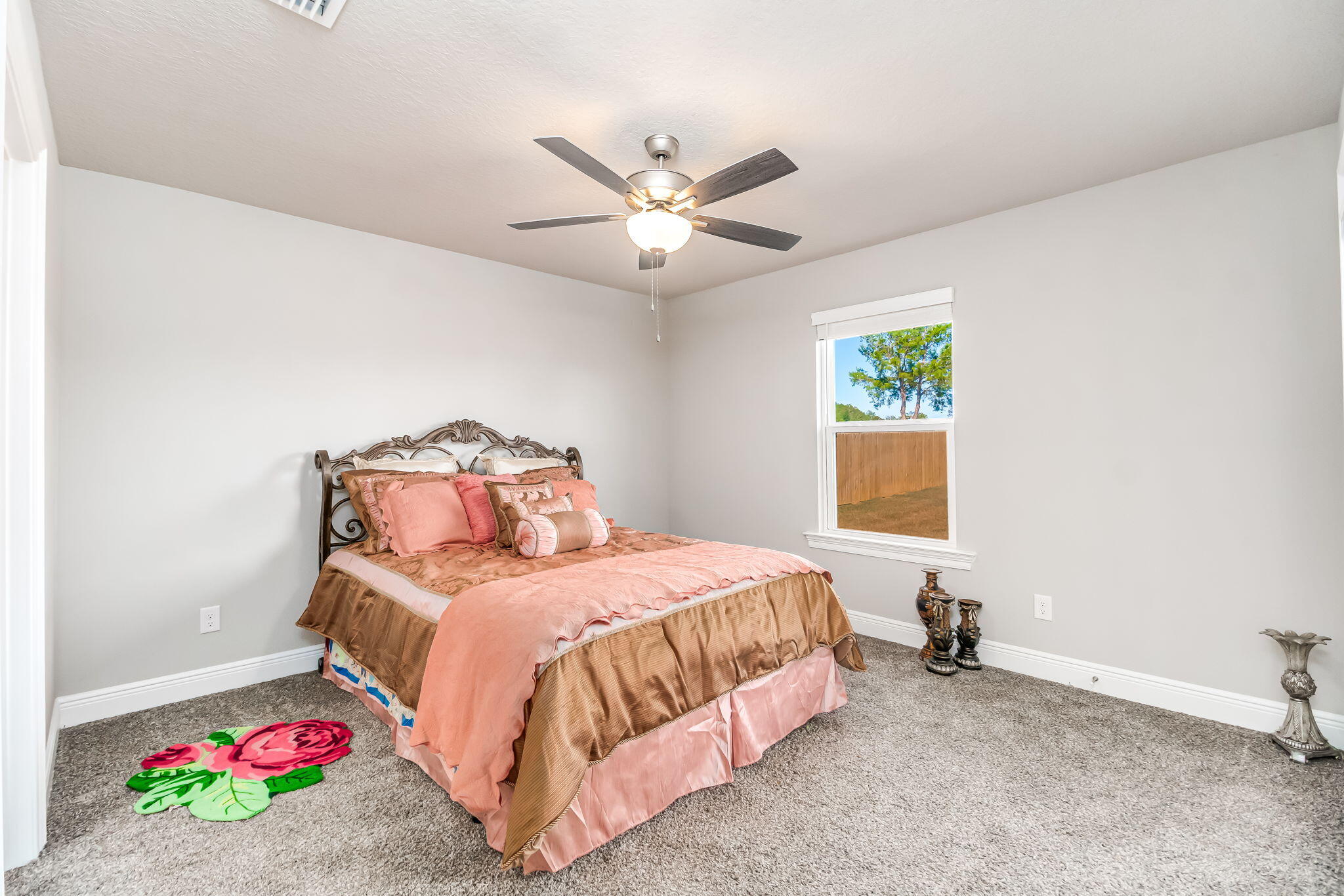 9188 Trident Road Milton, FL 32583 - Photo 23 of 47 a bedroom with a bed and a chandelier