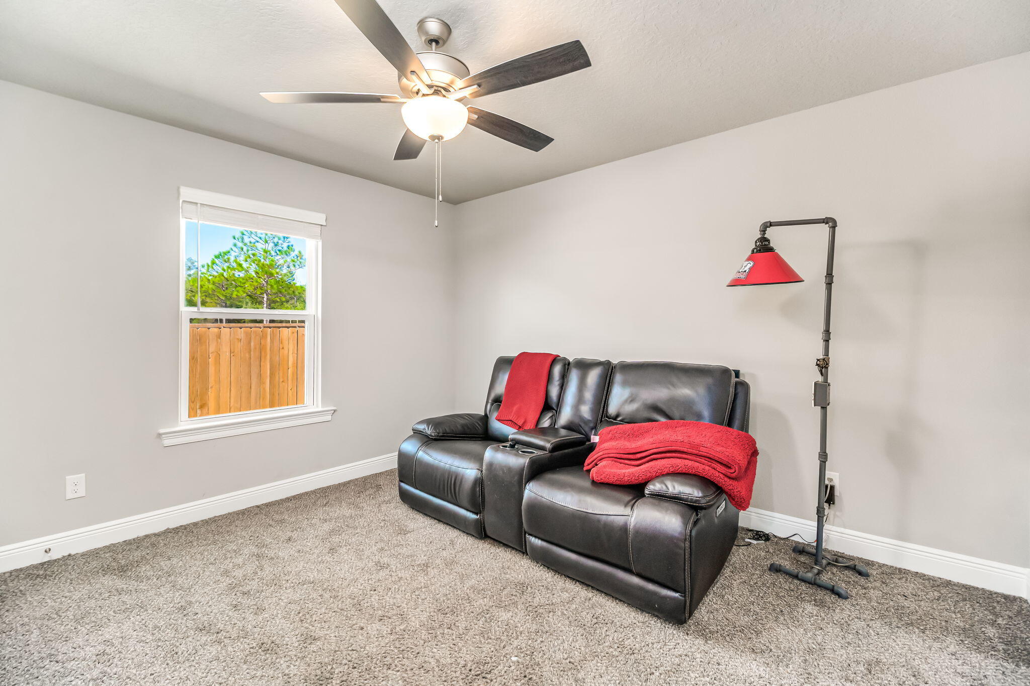 9188 Trident Road Milton, FL 32583 - Photo 29 of 47 a living room with furniture a bed and a chandelier