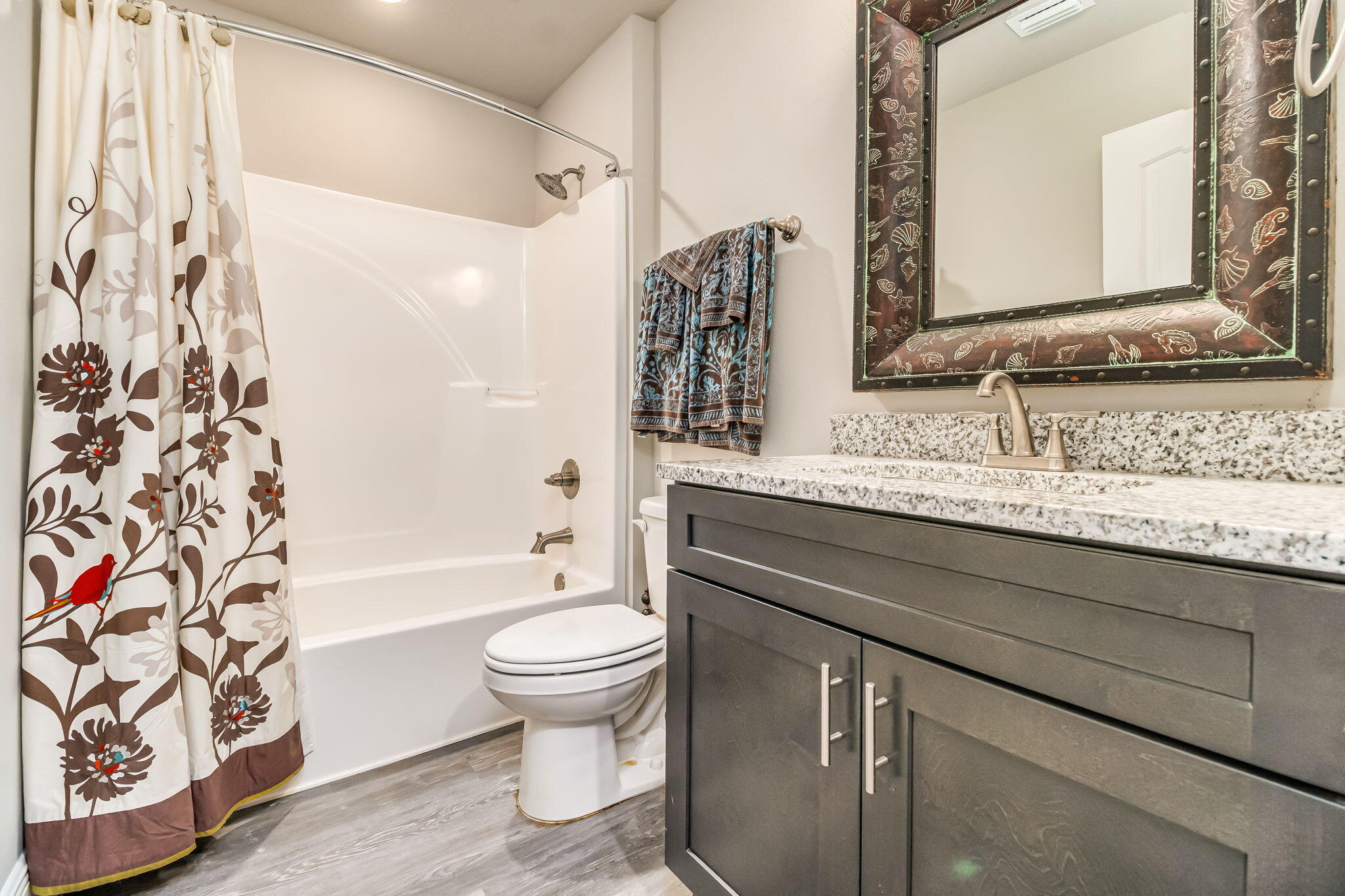 9188 Trident Road Milton, FL 32583 - Photo 31 of 47 a bathroom with a granite countertop toilet sink and a bathtub