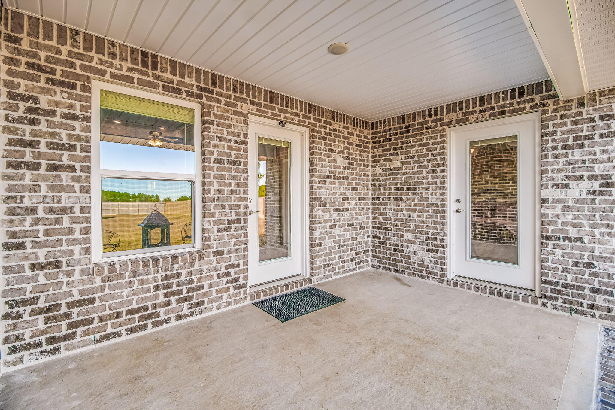 9188 Trident Road Milton, FL 32583 - Photo 35 of 47 view of a brick house with a large window