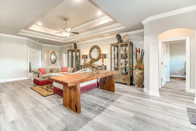 a large room with kitchen island a chandelier and a view of living room