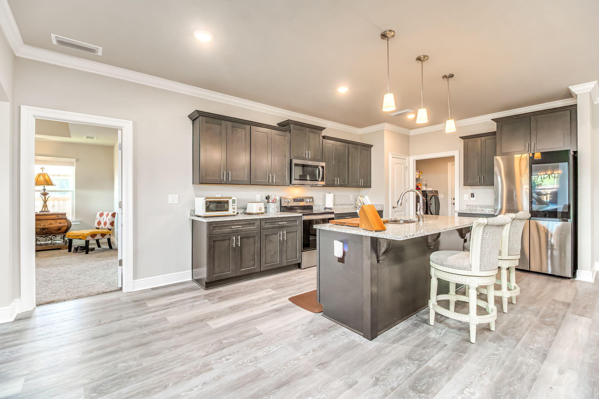 9188 Trident Road Milton, FL 32583 - Photo 9 of 47 a kitchen with a sink a counter top space and stainless steel appliances