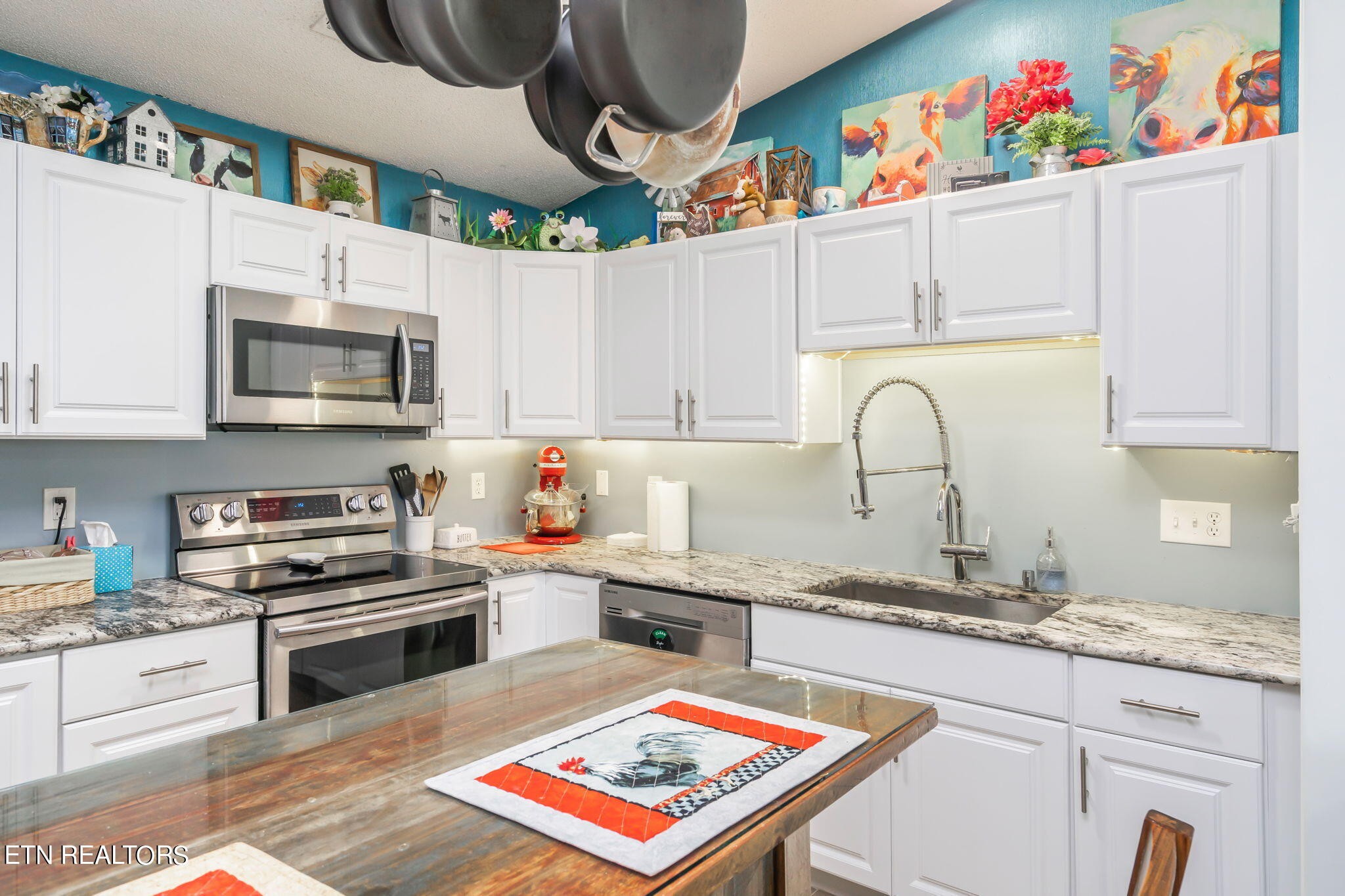 705 High Point Way, Knoxville, TN 37912 - Photo 11 of 22 a kitchen with granite countertop stainless steel appliances and a sink