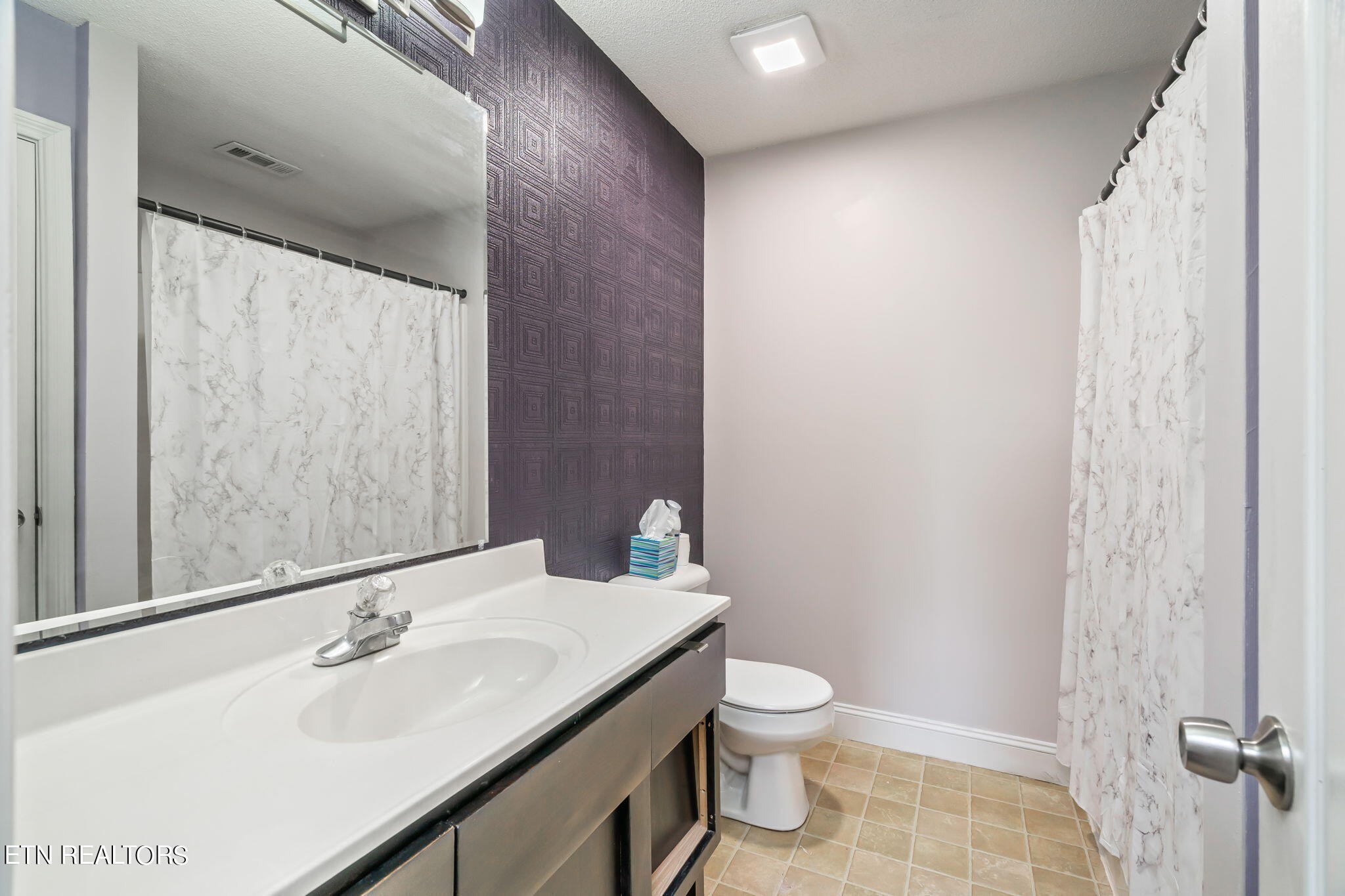 705 High Point Way, Knoxville, TN 37912 - Photo 17 of 22 a bathroom with a sink and a mirror