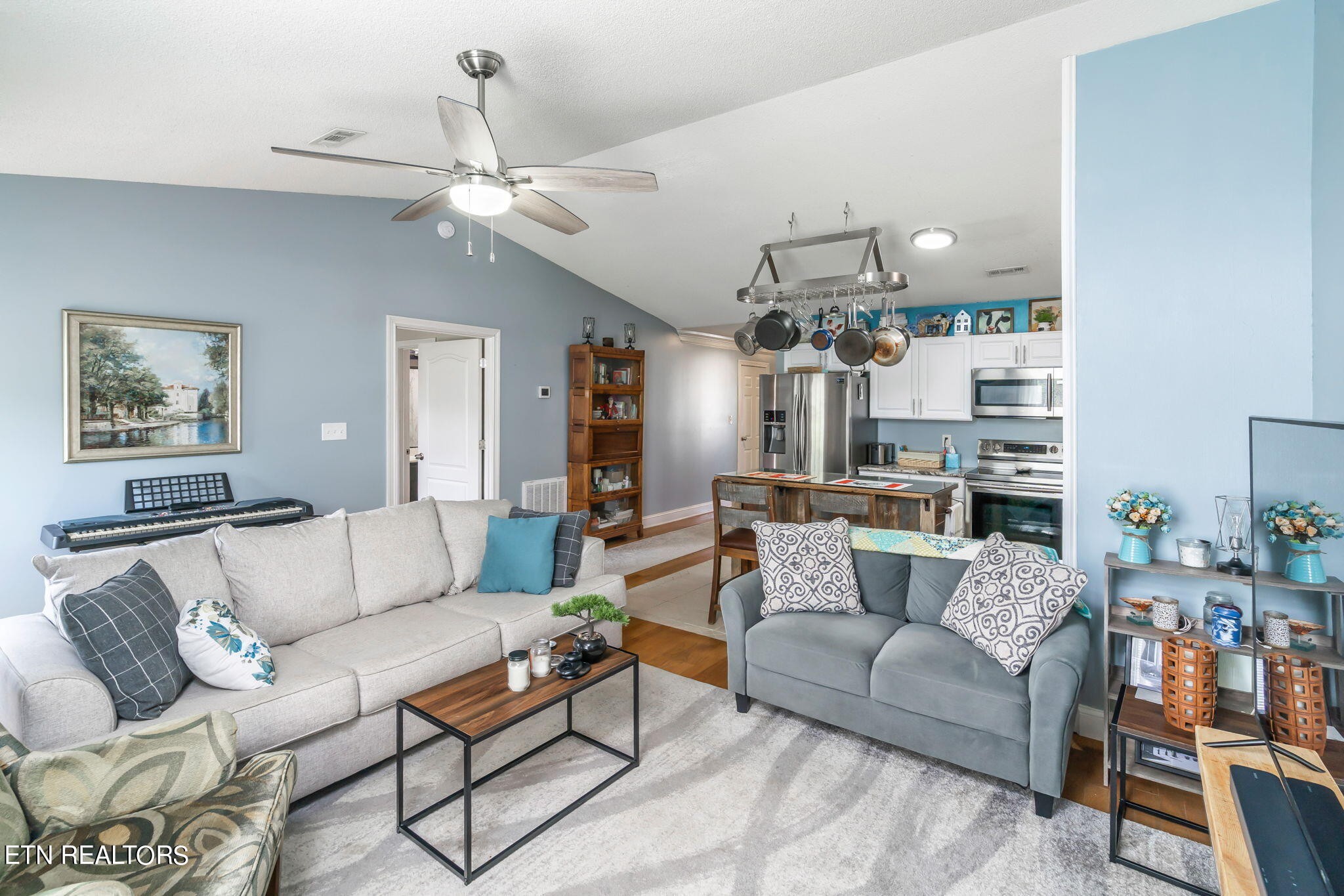 705 High Point Way, Knoxville, TN 37912 - Photo 3 of 22 a living room with furniture a chandelier and a flat screen tv