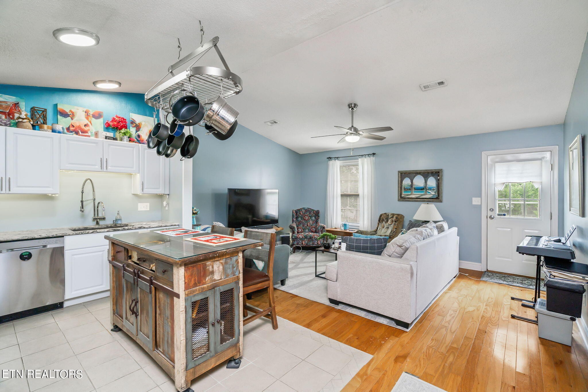705 High Point Way, Knoxville, TN 37912 - Photo 9 of 22 a view of a kitchen with kitchen island stainless steel appliances microwave stove a sink and a chandelier