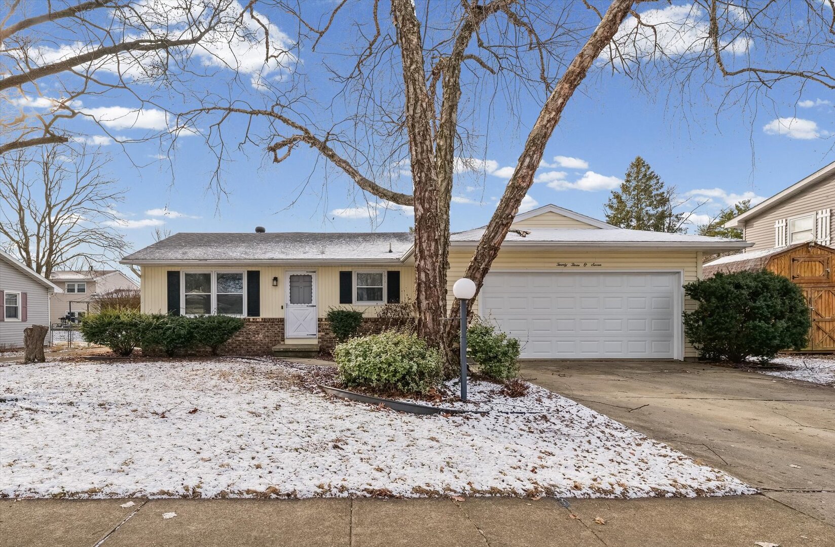 2307 Branch Road Champaign, IL 61821 - Photo 1 of 26 a front view of a house with a yard and potted plants