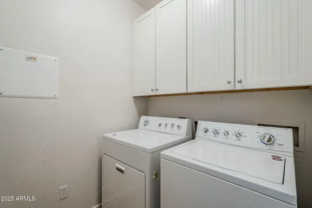 a view of storage and utility room with washer and dryer