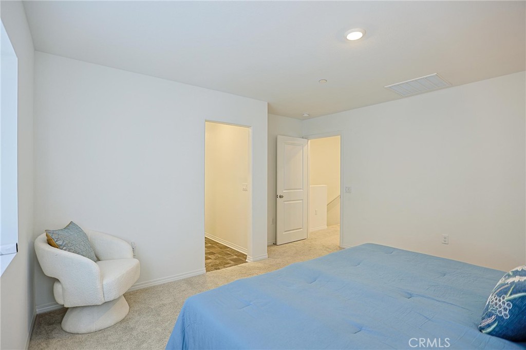 7486 Olive Grv Street Riverside, CA 92507 - Photo 28 of 57 a bedroom with a bed and a couch