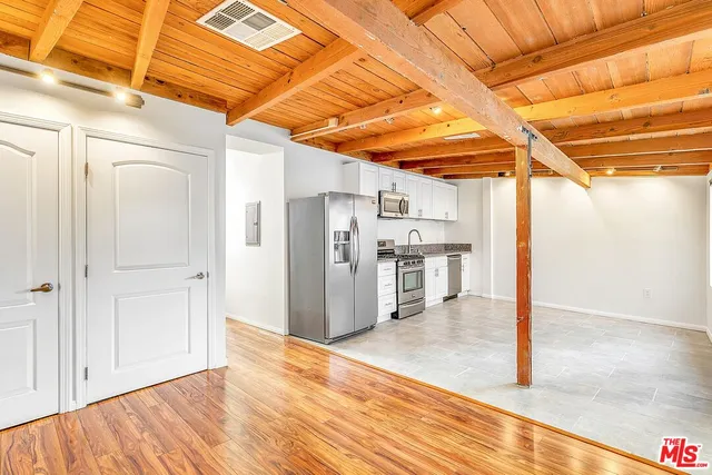 a view of a kitchen with wooden floor