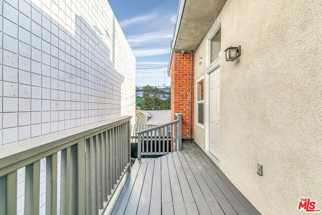 a view of a balcony with wooden floor